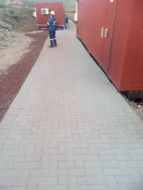 New brick paving along a row of site offices