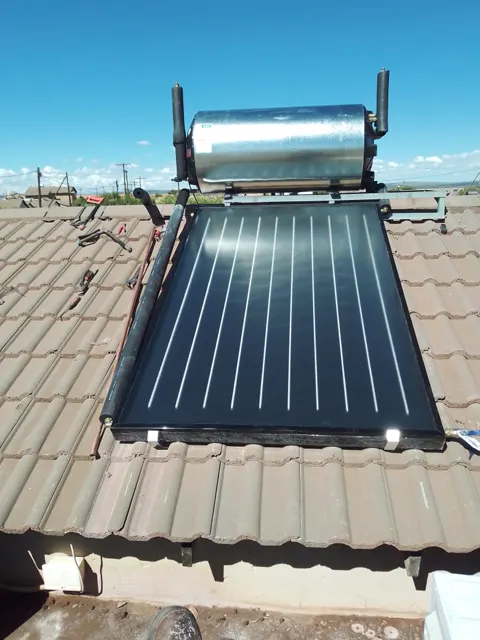 Flat-plate solar geyser on a tiled roof